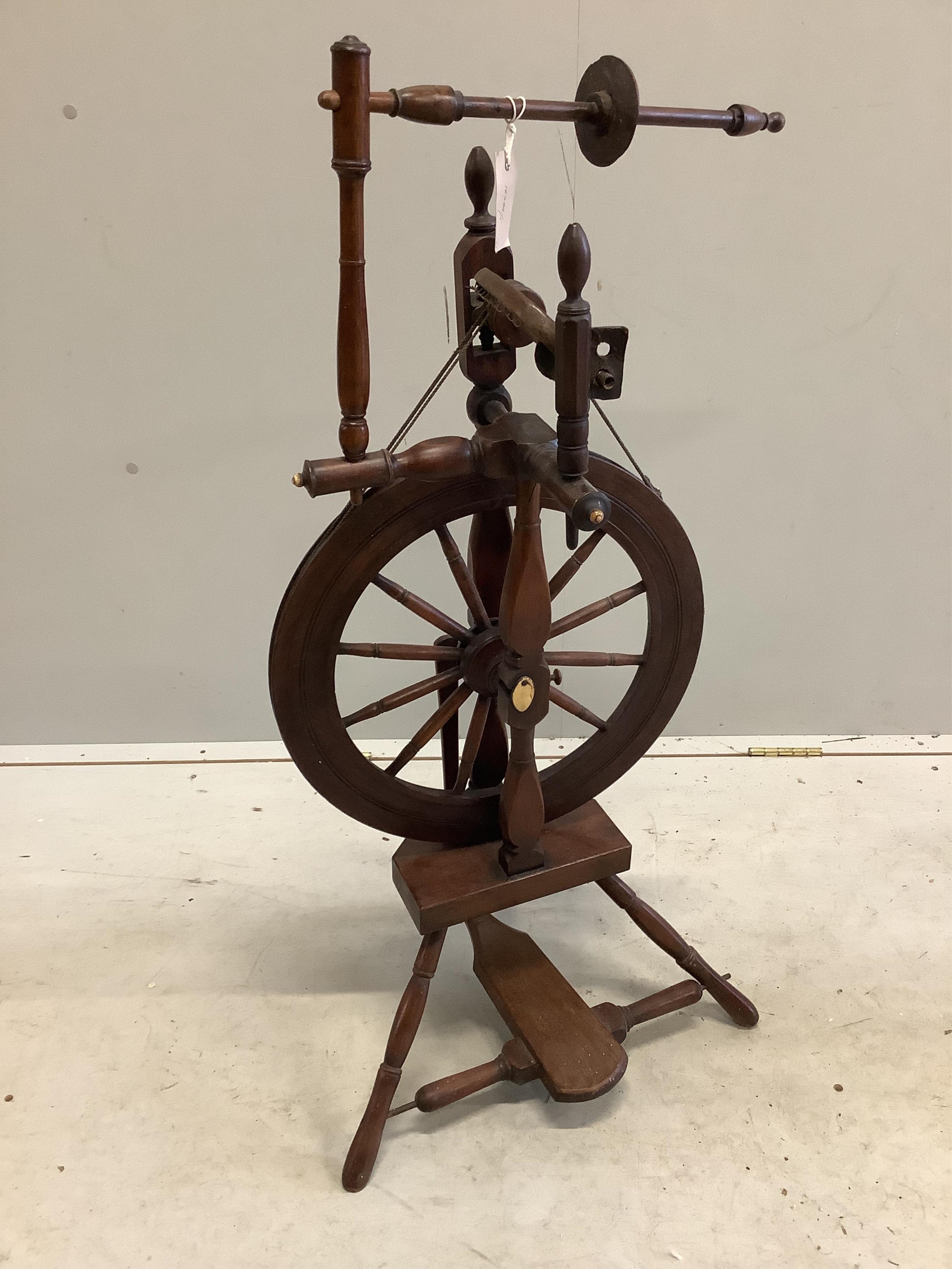 Two 19th century spinning wheels, larger height 124cm. Condition - fair